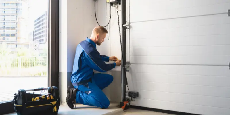 Technician doing garage door repair in Douglasville, Georgia.