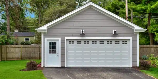 Free-standing garage with a fence in the background - commercial garage doors in Newnan, GA